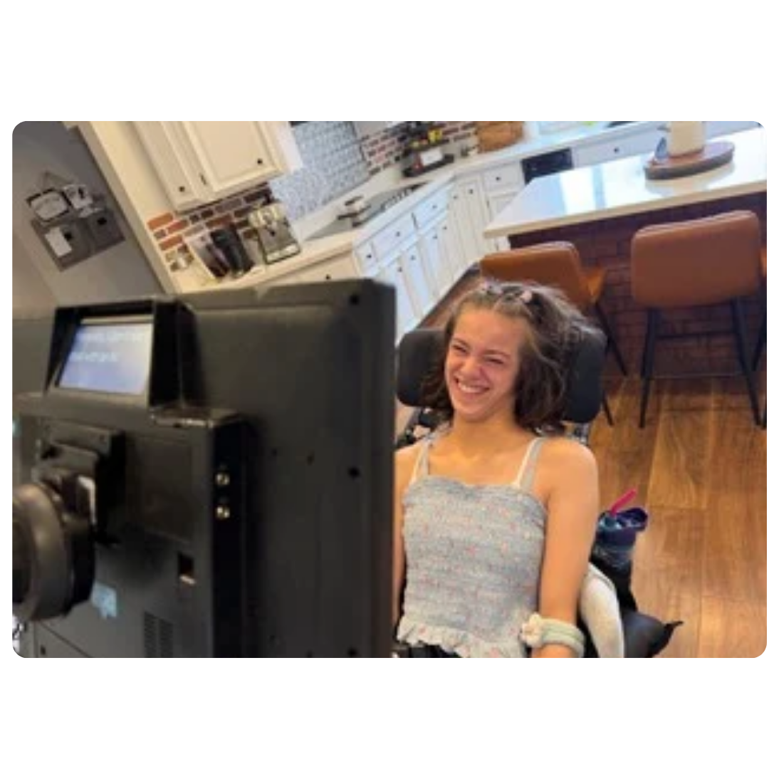 Trinity Joy at home looking at her Grid Pad device wuth eye gaze