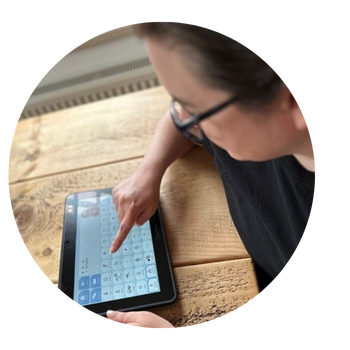 AAC user Alex is using her Grid Pad.
