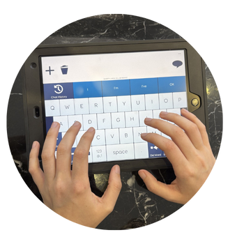 Sophie's hands seen using Alpha Core on our Talk Pad AAC device.