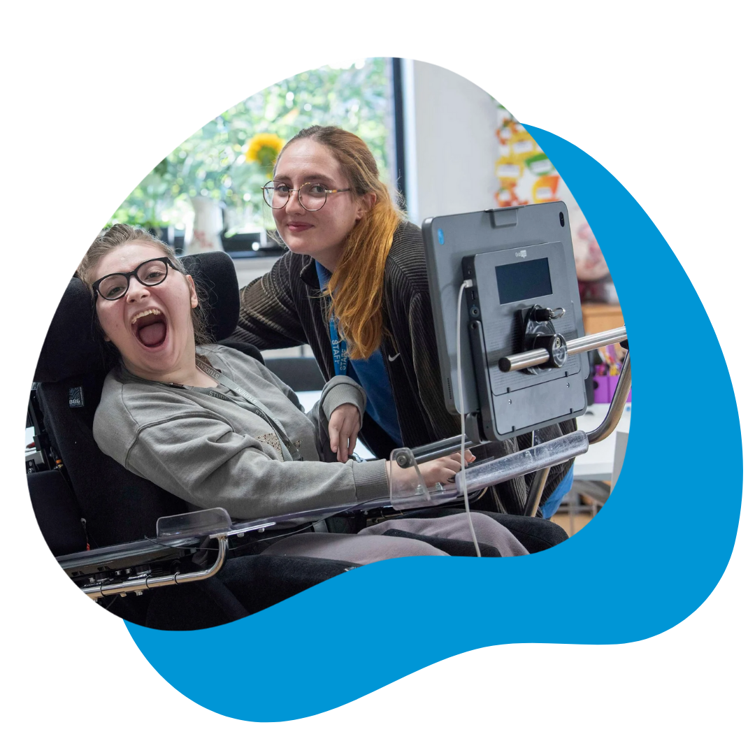 AAC user Milly using her Grid Pad with her communication partner