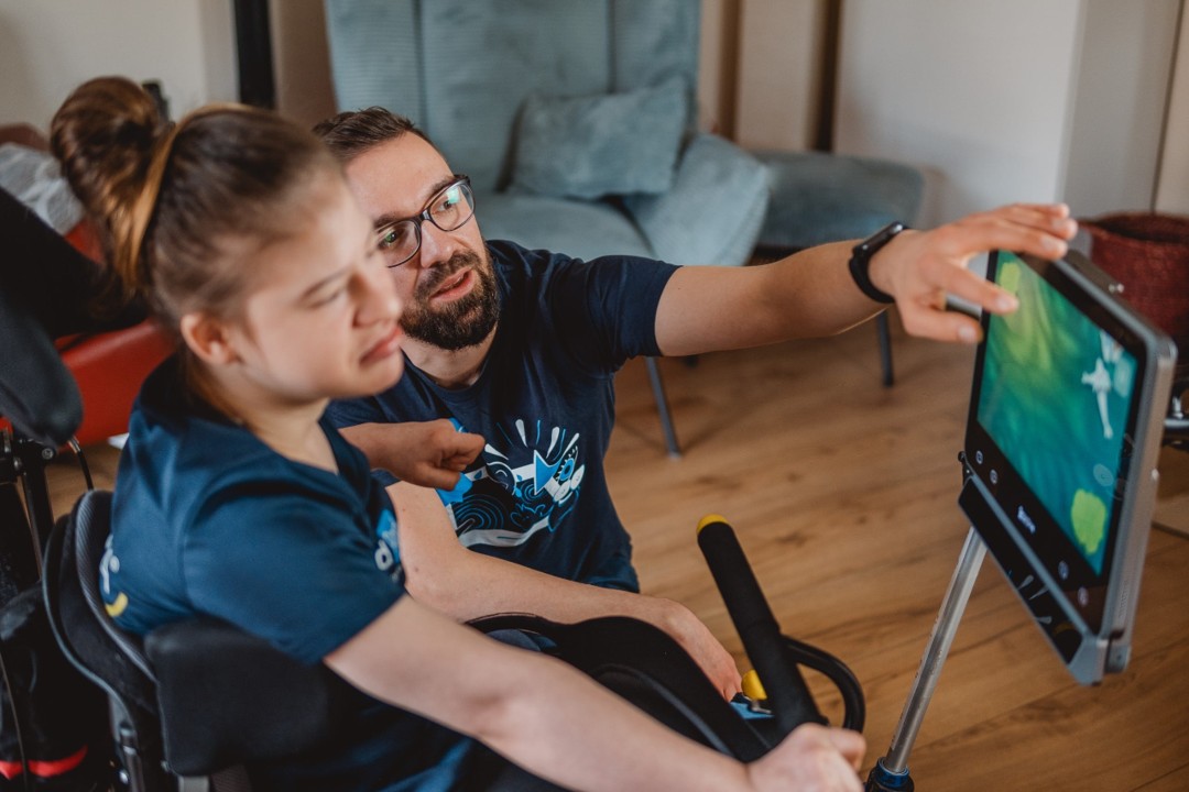 A man and woman looking at a Grid Pad with a Vida eye tracker