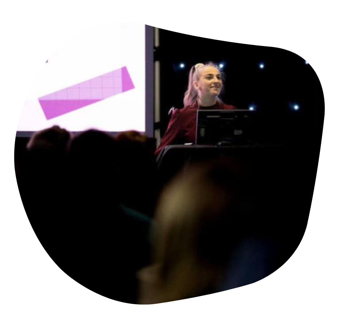 Ellise speaking in public at a lectern