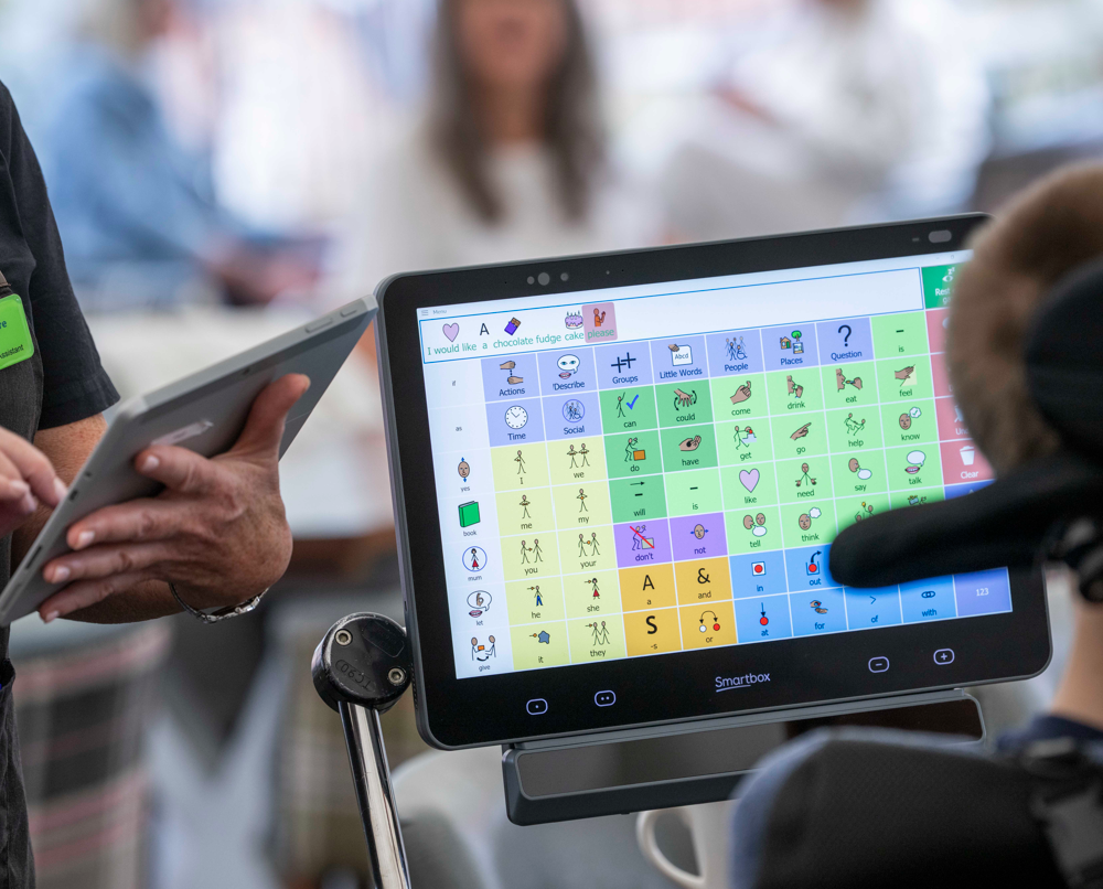Samuel making an order at a cafe using his Grid Pad and Evo