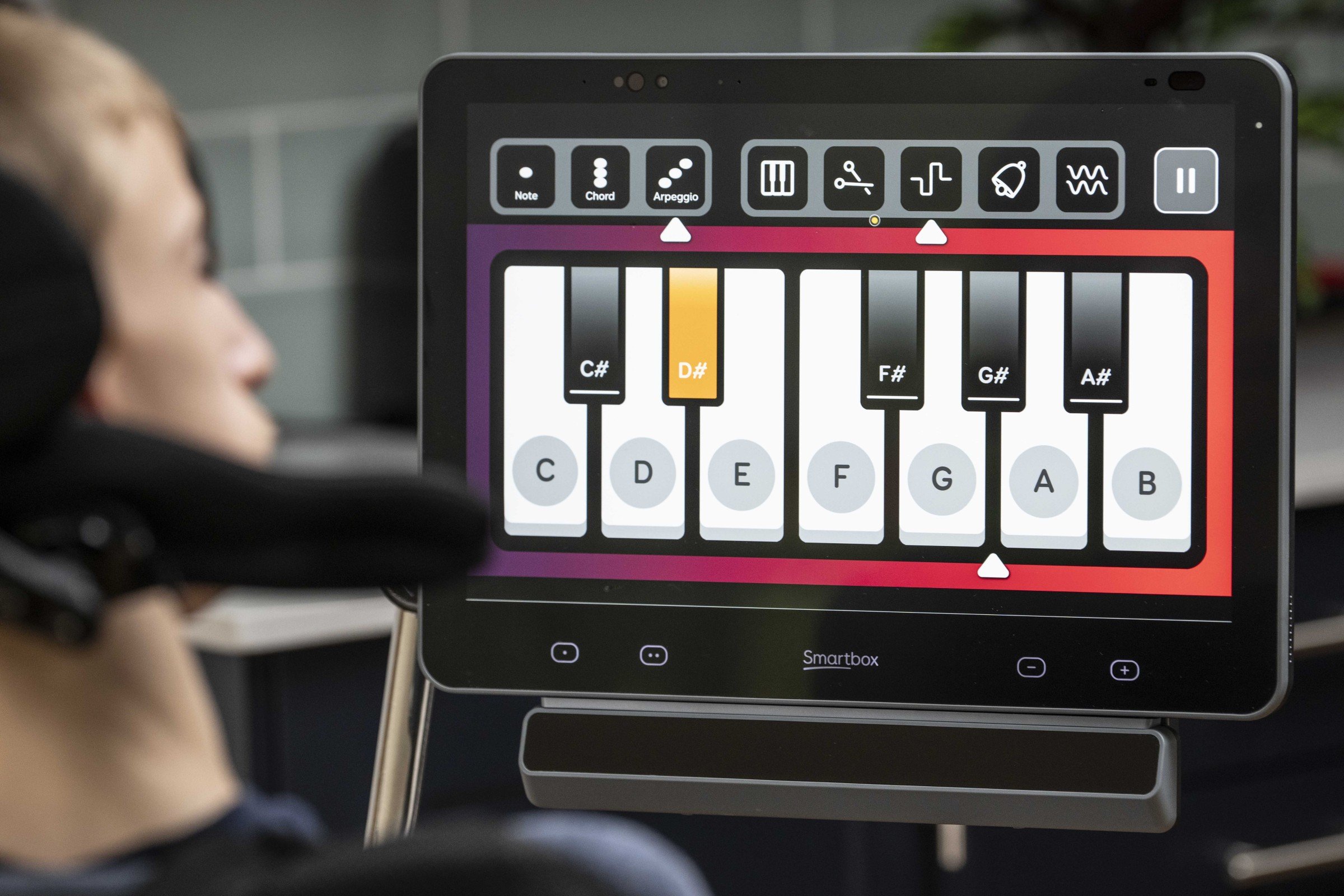 Powered by machine learning - Samuel with his Evo and Grid Pad 16 showing a piano keyboard on the screen.