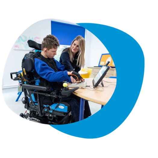 What can dual access look like? A person in a wheelchair using their Grid Pad device with dual access and a SLP is seated beside them