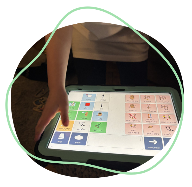 A child using a touch screen Grid Pad to communicate