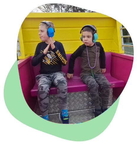 Tristan and Sullivan sitting together in a playground